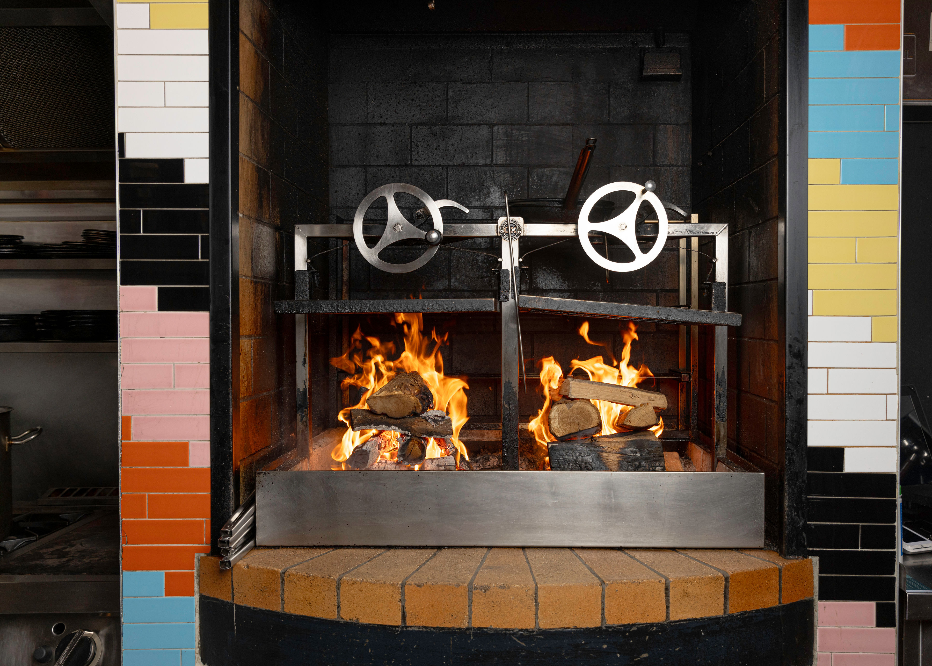 Open wood fire and rotisserie grill inside Elbow Lane Smokehouse and Brewery in Cork